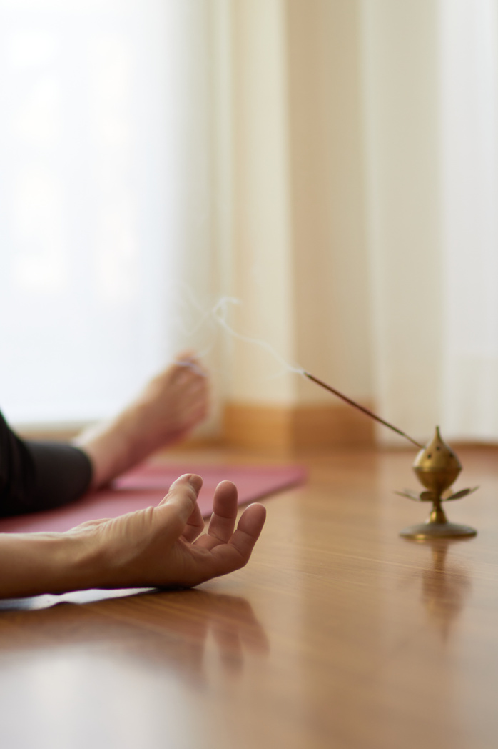 woman practicing yoga, lying in yoga nidra pose, exercise in Shavasana, exercises, work, rest after practice, female hand.